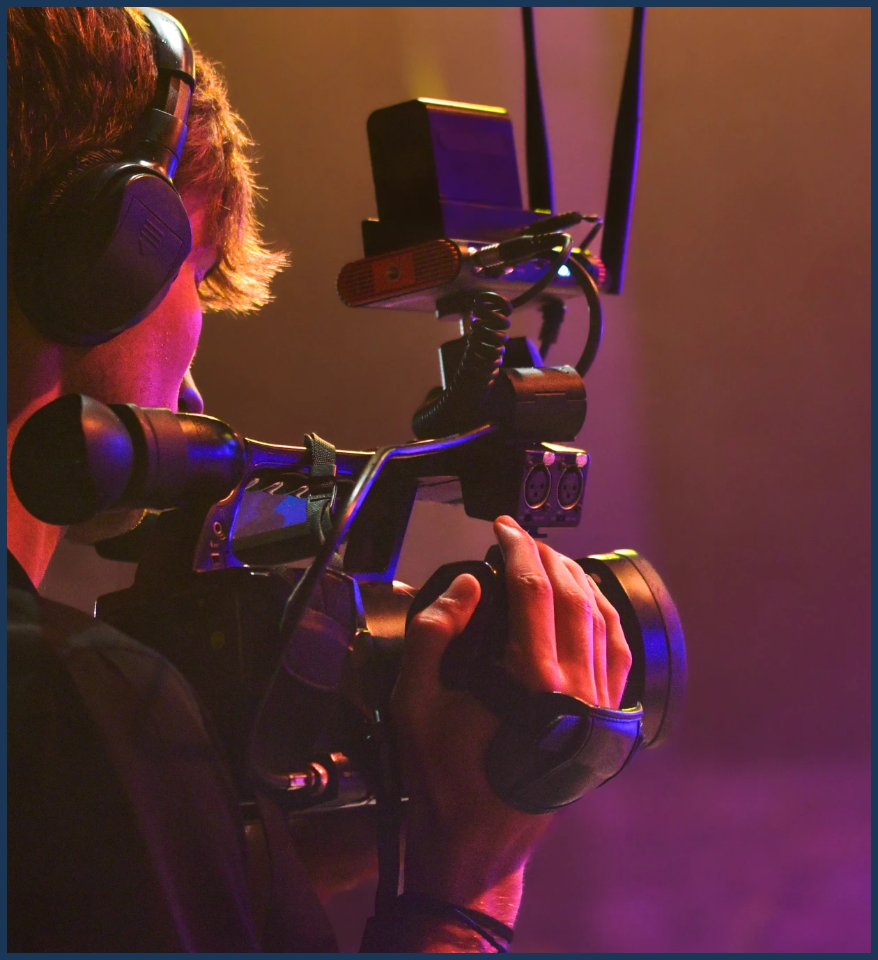 Videographer using camera on set