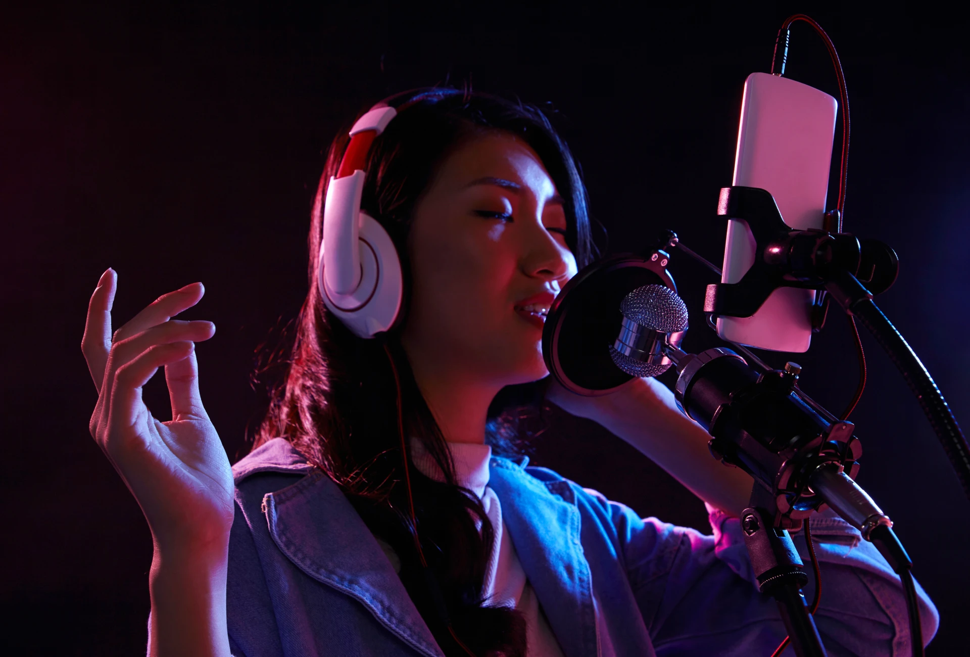 Woman wearing headphones singing